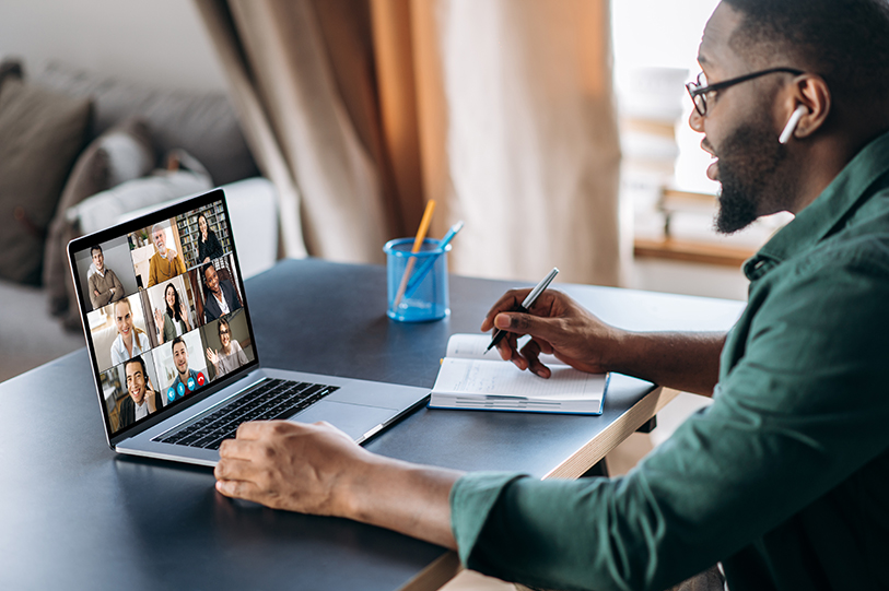 Online business briefing. Male African American employee speak on video call with diverse multiracial colleagues, on laptop screen diverse business people, meeting online, group discussing on how they are managing remote employees
